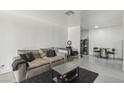 Spacious living room with a large sofa, desk area, and sleek black coffee table at 3008 Saint George St # F, North Las Vegas, NV 89030