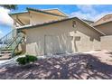 Condo exterior featuring back storage room with three separate doors and a staircase at 338 Jett St # 101, Las Vegas, NV 89145