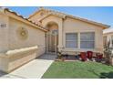 Charming single-story home featuring a desert landscaping and security gate at 5580 Lonesome Biker Ln, Las Vegas, NV 89113