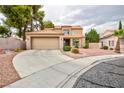 Well-maintained single-Gathering home with a two-car garage and a desert-landscaped front yard at 9836 Russett Wood Cir, Las Vegas, NV 89117