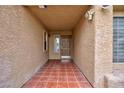 Inviting front porch featuring stylish tile flooring and a warm, neutral color scheme at 9836 Russett Wood Cir, Las Vegas, NV 89117