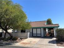 Charming single-story home with a lovely red-tiled roof, mature tree, and an inviting carport at 1731 Paloma Ave, Laughlin, NV 89029
