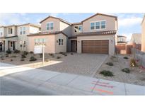 Two-story house with brown garage door and landscaped front yard at 5925 Flowering Hill Ct, Las Vegas, NV 89131