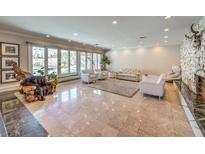 Spacious living room with stone fireplace, and large windows at 1420 S 8Th St, Las Vegas, NV 89104