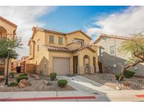 Charming two-story home featuring desert landscaping, a tile roof, and an attached garage at 1161 Gecko Rd, Henderson, NV 89002
