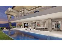 Stunning modern home featuring a luxurious pool, spacious patio, and ocean views, perfect for outdoor living and entertaining at 616 Scenic Rim Dr, Henderson, NV 89012