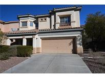 Inviting two-story home featuring a neutral color palette, desert landscaping, and a spacious two-car garage at 6020 Genovese Ave, Las Vegas, NV 89141