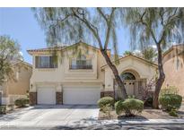 Charming two-story home with a well-manicured front yard and a two-car garage, framed by mature trees at 3179 Surf Spray St, Las Vegas, NV 89117