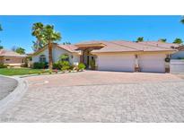 Beautiful single-story home with three-car garage, mature landscaping, and a paved driveway at 2290 Casa Bella Ct, Las Vegas, NV 89117