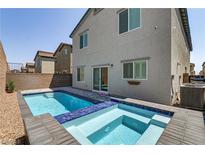 A backyard pool and hot tub with a blue tile trim in a desert landscaped private backyard at 8351 Gold River Ct, Las Vegas, NV 89113