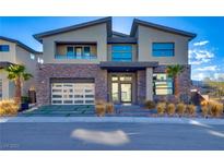 Two-story modern home with stone accents and a three-car garage at 10632 Patina Hills Ct, Las Vegas, NV 89135