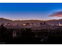 Stunning aerial view of property with city skyline and mountain backdrop at 7090 Fazio Dr, Las Vegas, NV 89110