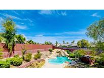 Beautiful backyard pool with a slide and lush landscaping, perfect for outdoor entertainment at 5301 Fairbranch Ln, Las Vegas, NV 89135