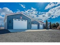 Charming home featuring a three-car garage and well-maintained gravel landscaping at 3301 Rodeo Ave, Pahrump, NV 89048