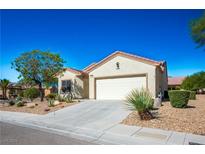 Single-story house with a two-car garage and desert landscaping at 3320 Kookaburra Way, North Las Vegas, NV 89084