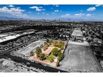 Aerial view of house, large yard, and surrounding city views at 1860 E Ford Ave, Las Vegas, NV 89123