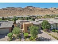 Aerial view of a modern house with desert landscaping and mountain views at 10057 Regency Canyon Way, Las Vegas, NV 89148