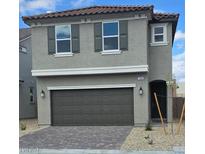 Two-story home featuring a two-car garage, gray paint, and complementary brown shutters and roof at 7086 Parkallen Ave, Las Vegas, NV 89113