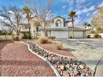 Two-story house with a three-car garage and landscaped yard at 9917 Aspen Knoll Ct, Las Vegas, NV 89117