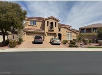 Charming two-story home with a red tile roof, multiple-car garage, and well-manicured front yard at 2742 Kingclaven Dr, Henderson, NV 89044