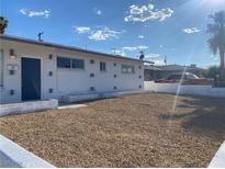 Ranch style home with a gravel front yard and blue front door at 4313 El Conlon Ave, Las Vegas, NV 89102