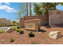 Westridge Village stone sign in front of landscaped common area with block perimeter wall on a sunny day at 1629 Black Fox Canyon Rd, Henderson, NV 89052