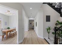 Bright hallway with dining area featuring wood floors and modern lighting at 17 Winding Rd, Henderson, NV 89052