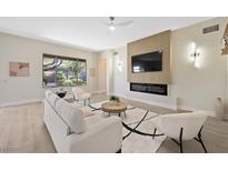 Bright living room features a modern fireplace, large window, and contemporary furnishings at 17 Winding Rd, Henderson, NV 89052