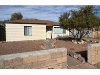 Ranch style home with landscaped front yard and block wall at 132 W Victory Rd, Henderson, NV 89015