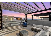 Relaxing rooftop deck with pergola, seating area, and city views at 651 Sentinel Spire St, Las Vegas, NV 89138