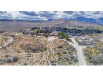 Scenic aerial view of a small desert town surrounded by mountains under a cloudy sky at 16 Cerrito St, Blue Diamond, NV 89004