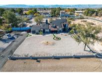 Spacious property with modern home, gravel yard, solar panels, mountain views, and decorative front turf at 7135 Polaris Ave, Las Vegas, NV 89118