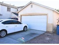 Attached garage with white door and ample space for one car at 4657 Coronado Hills Way, Las Vegas, NV 89115