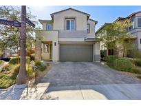 Contemporary two-story home with a two-car garage and modern gray brick driveway at 5 Vicolo Loren, Henderson, NV 89011