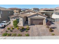 Single-story home with a two-car garage and landscaped front yard at 1324 Cattail Falls St, Boulder City, NV 89005
