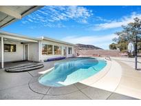 Inviting backyard pool with mountain views, surrounded by ample patio space for entertaining at 360 E Kimberly Dr, Henderson, NV 89015