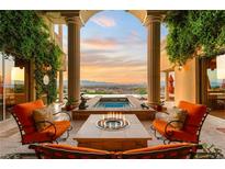 Stunning outdoor patio with a fire pit, spa, city view, and comfortable seating, perfect for relaxation at 1309 Imperia Dr, Henderson, NV 89052