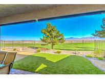 Relaxing covered back patio with artificial turf and scenic golf course views at 4286 E Cactus Canyon Dr, Pahrump, NV 89061