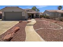 Charming one-story home with a welcoming walkway and low maintenance rock landscaping at 1195 Sunfire St, Henderson, NV 89014