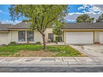 Charming single-story home with a well-maintained lawn, mature landscaping, and an attached two-car garage at 5701 Pearldrop Ave, Las Vegas, NV 89107