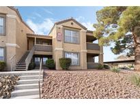 Two-story condo building with stairs and landscaping at 2300 E Silverado Ranch Blvd # 1165, Las Vegas, NV 89183