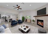 Bright living room featuring fireplace, high ceilings, and open floor plan at 7803 Canoe Ln, Las Vegas, NV 89145