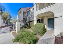Inviting exterior with landscaped walkway leading to the front door and stairway at 4860 Nara Vista Way # 104, Las Vegas, NV 89103