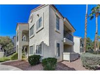 Spanish-style condo building with attractive landscaping and desert plants at 4860 Nara Vista Way # 104, Las Vegas, NV 89103
