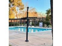 Community pool with clear blue water and ample lounging space at 310 Brookside Ln # B, Las Vegas, NV 89107