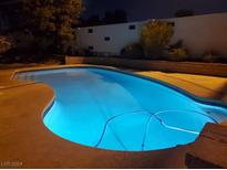 Inviting backyard pool featuring cool blue water and a tiled edge, perfect for evening relaxation and backyard gatherings at 4369 Greenhill Dr, Las Vegas, NV 89121