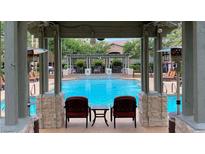 Beautiful community pool featuring seating with a relaxing view of the water at 8721 Red Brook Dr # 203, Las Vegas, NV 89128