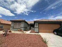Charming single-story home with desert landscaping and a two-car garage, displaying a cozy and inviting curb appeal at 5025 Vista Loma Way, North Las Vegas, NV 89031