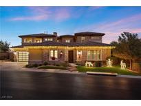 Two story home with a three car garage and landscaped yard at 4 Olympia Chase Dr, Las Vegas, NV 89141