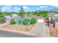 Cute teal home with a large driveway and a small front yard, in a residential neighborhood at 6552 Roy Rogers Dr, Las Vegas, NV 89108